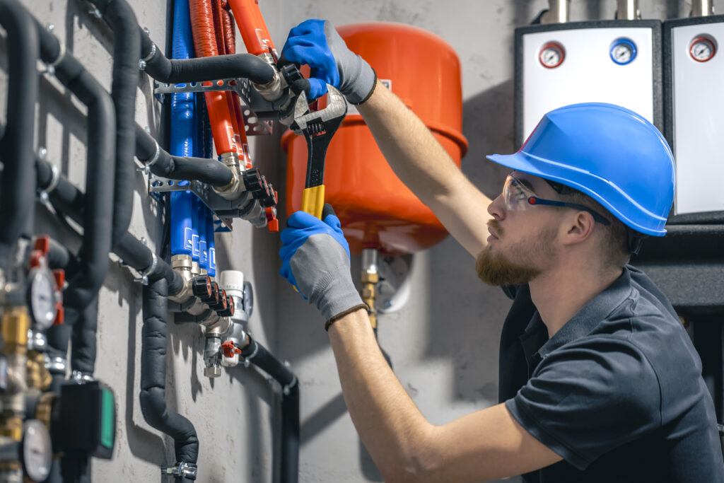 man-installs-heating-system-house-checks-pipes-with-wrench (1)